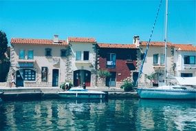 boats canal water buildings houses