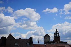City roofs sky clouds view