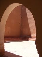 arched doorway in ancient stone wall, morocco, medina