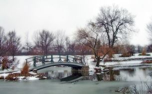 small bridge over the river in a winter park