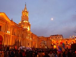 People in the background of the illuminated cathedral in Arequipa