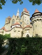 medieval castle behind green bushes