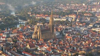 Ulm Cathedral in the background of city buildings aerial view