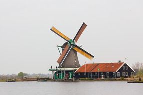 Big windmill on a lake bank near the water