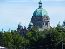 domes of parliament building behind trees, canada, british columbia, victoria