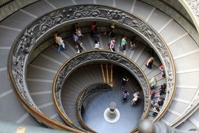 people walking down the spiral staircase