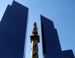 statue among skyscrapers