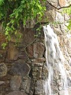 small waterfall on the stone wall