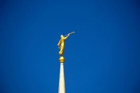 Golden statue on church blue sky view