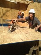 woman working with power tool on construction site
