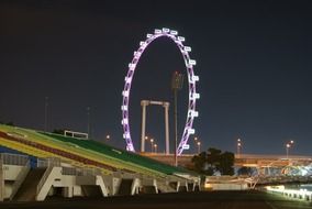 the ferris wheel on the background of night sky in Singapore