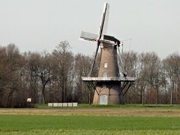 windmill in front of bare trees, netherlands, juffer