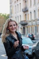 blonde in a leather jacket on a street in Moscow