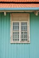 corrugated iron of the pastel-green building with orange roof