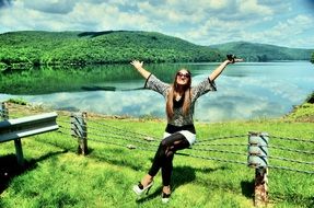 girl posing on the background of the lake