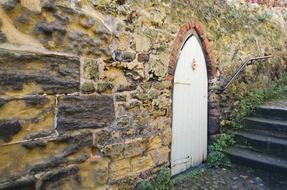 white door in an old stone wall