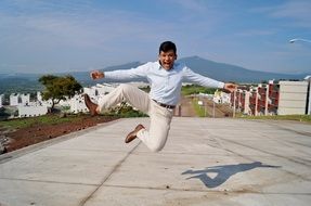 happy man jumping on the road