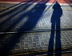 shadow man on the city pavement