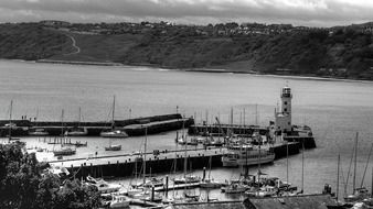 Black and white photo of the landscape with boats at port, uk, harbor city