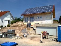 A concrete mixer stands near a house in Germany