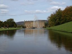 distant view of chatsworth house near lake