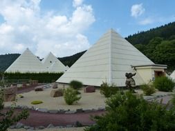 landscape of white pyramids and a green hill