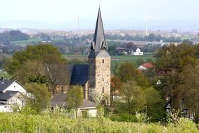 church among trees in a valley in westphalia