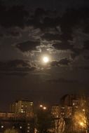moon in the clouds over night osiedle