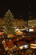 lights of christmas market in city at night