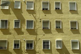 a lot of windows on a Yellow building