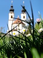 church behind green grass in a blurred background