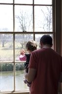 father and daughter by the window