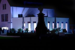 Modern façade of the villa at night with lighting