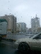 city street with cars in the rain