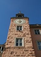 pink clock tower of palace at blue sky, germany, schwetzingen