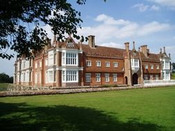 historical brick building on lawn, uk, england, suffolk