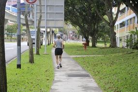 running man on street pedestrian pathway