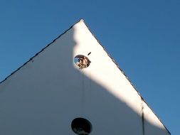 sculptures of angels in the window on the roof of the house