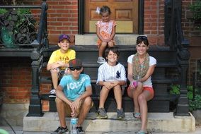 family sitting on stairs
