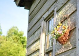 Basket of flowers on a wood house