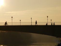 people and street lights on the bridge