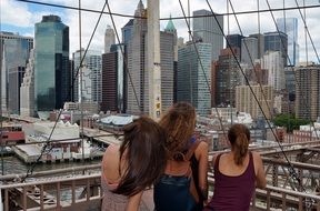 Girls looking from the bridge at skyscrapers, usa, manhattan, nyc