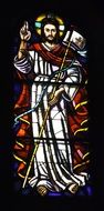 saint on colorful stained glass window