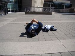 photographer lying on the ground photographs a building