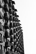 side view of a gray high rise building with balconies