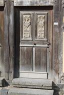 wooden front door in an old brick building