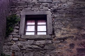 window on the stone wall of the building