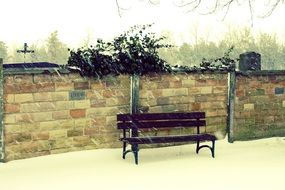 bench near a brick fence