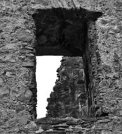 black and white photo of a window in a medieval church