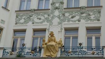 golden sculpture on the balcony of the house